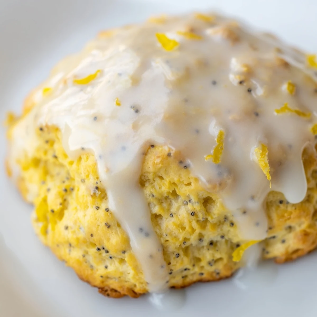 Warm Lemon Poppy Seed Scones dusted with poppy seeds, served alongside a steaming cup of Earl Grey tea for breakfast.