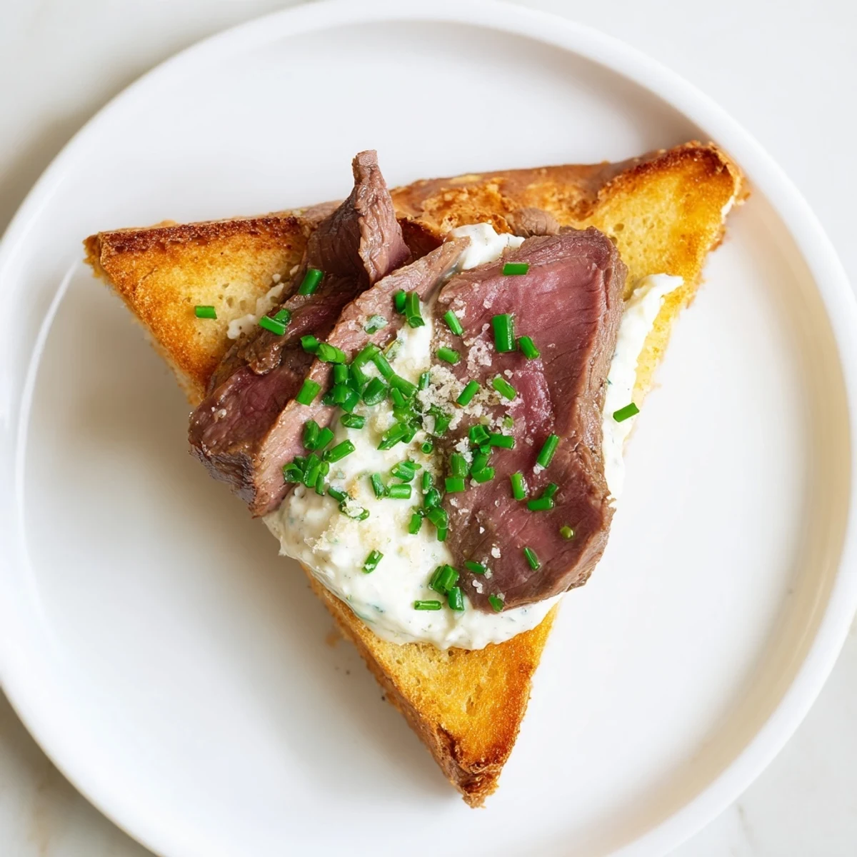 Buttery, crispy toast triangles topped with rare beef slices and zesty horseradish cream for dipping.