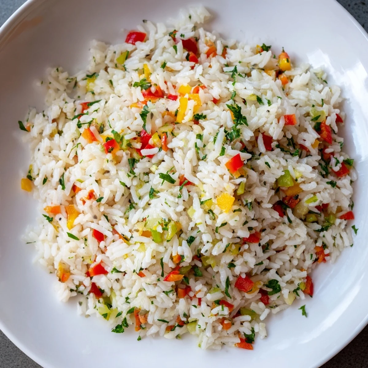 Aromatic Creole Rice Pilaf with Peppers steaming next to skillet, garnished with fresh parsley.