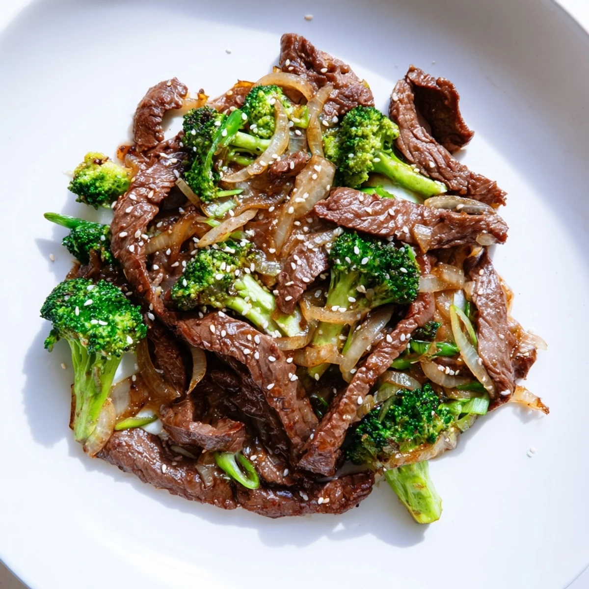 Fresh ingredients for Beef and Broccoli Stir Fry with Garlic Sauce arranged on a wooden board, including sliced beef, broccoli, and minced garlic.