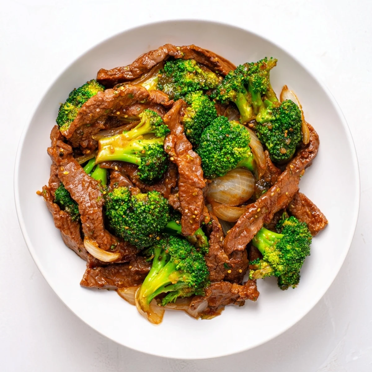 Steaming Beef and Broccoli with Soy Sauce in a glossy wok, tender beef and bright green broccoli florets coated in savory sauce.