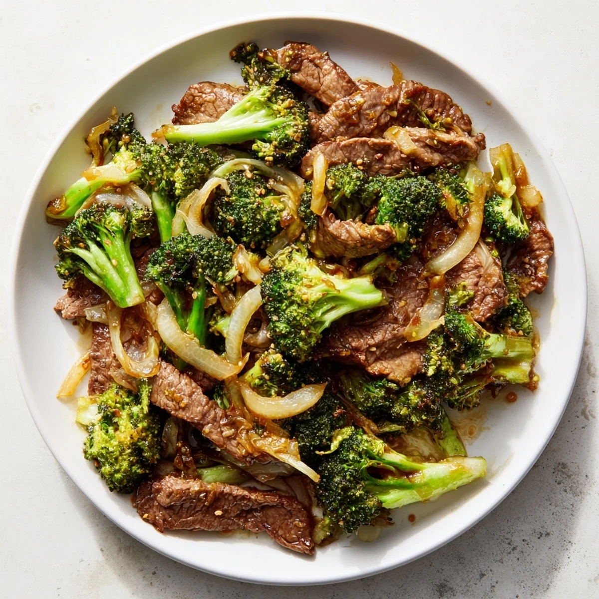 Beef and Broccoli with Soy Sauce served over white rice in a ceramic bowl, chopsticks resting nearby for an easy weeknight dinner.