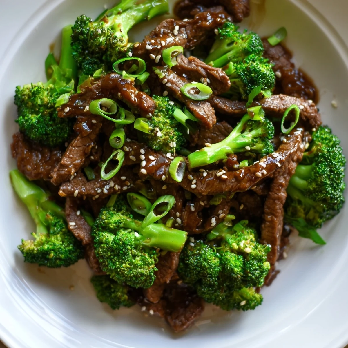 Close-up view of sizzling Beef and Broccoli with Soy Sauce Glaze in a wok, highlighting the thick, shiny sauce clinging to the ingredients during a busy weeknight cooking session.