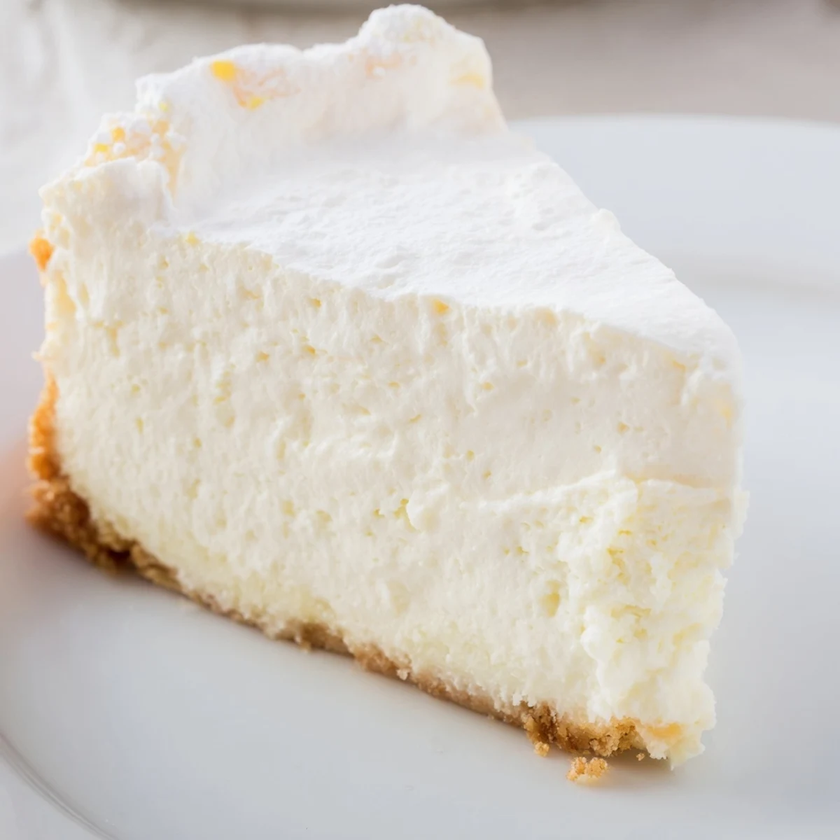 Rich Greek Yogurt Cheesecake served chilled, topped with fresh berries on a rustic wooden table.