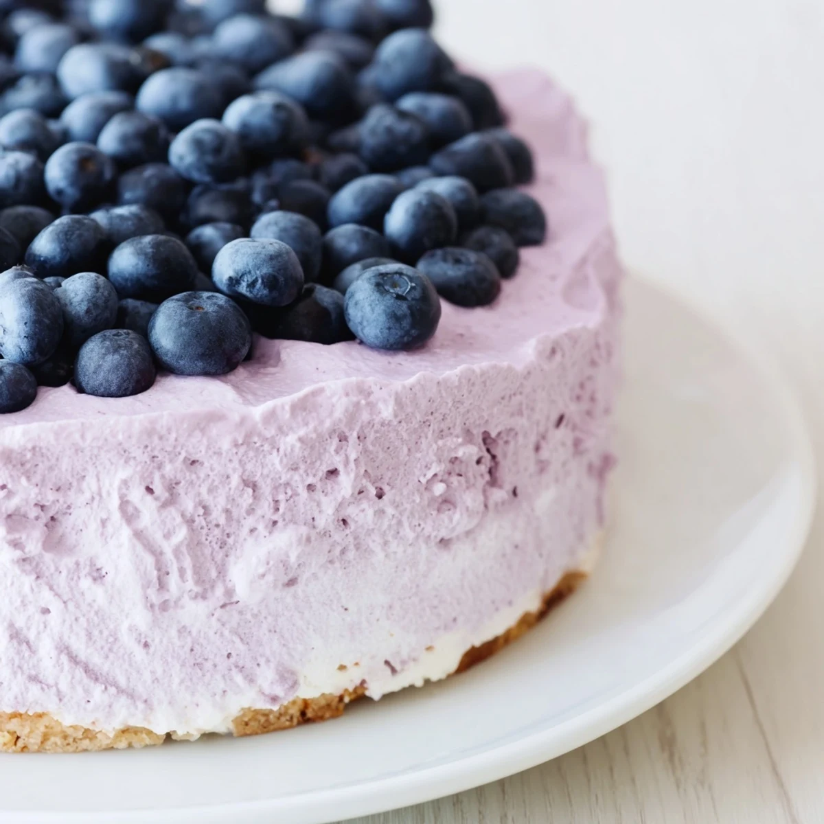This fresh Blueberry Mousse Cheesecake features a buttery graham cracker crust and smooth, velvety texture.