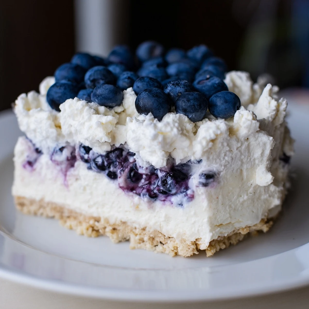A perfect Blueberry Mousse Cheesecake garnished with mint leaves, ideal for a summer dessert buffet.