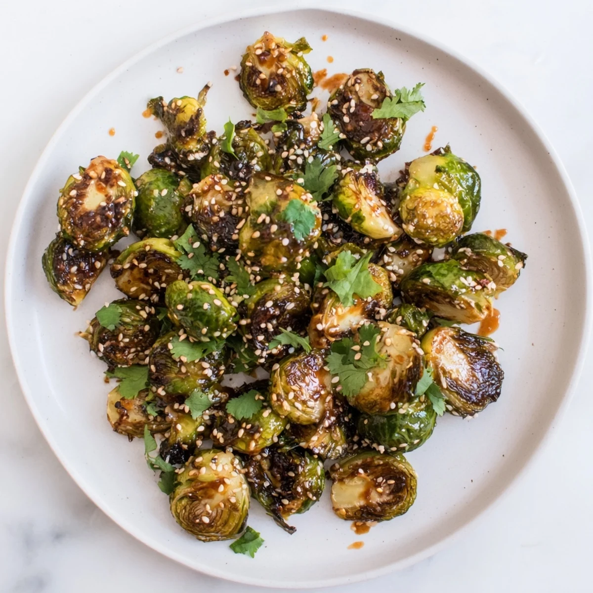 Roasted Honey Sriracha Brussels Sprouts served hot as a flavorful side dish garnished with sesame seeds.
