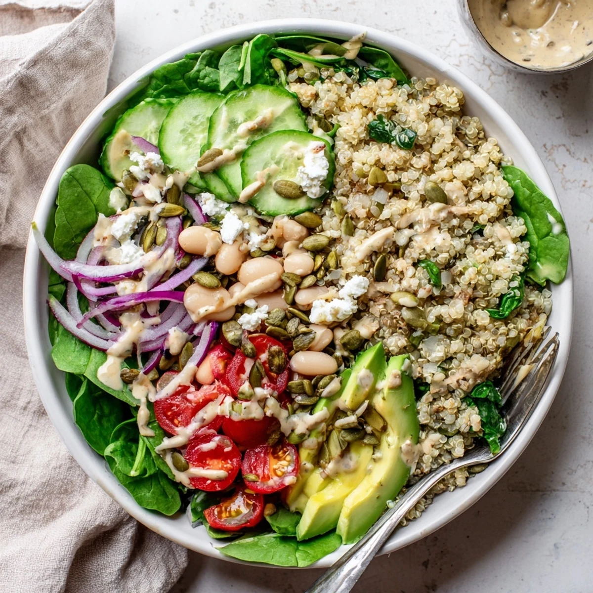 Vibrant cherry tomatoes, cucumber slices, and ripe avocado make this Spinach & White Bean Ultimate Protein Power Bowl a colorful and filling main dish.
