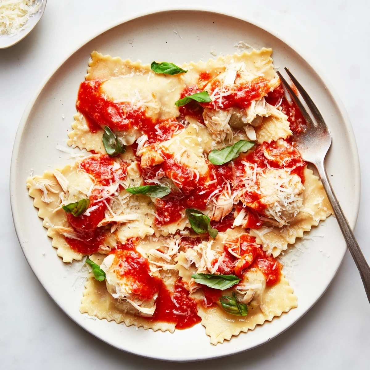 Tender chicken and earthy mushrooms fill delicate ravioli, nestled in a bright homemade tomato sauce.