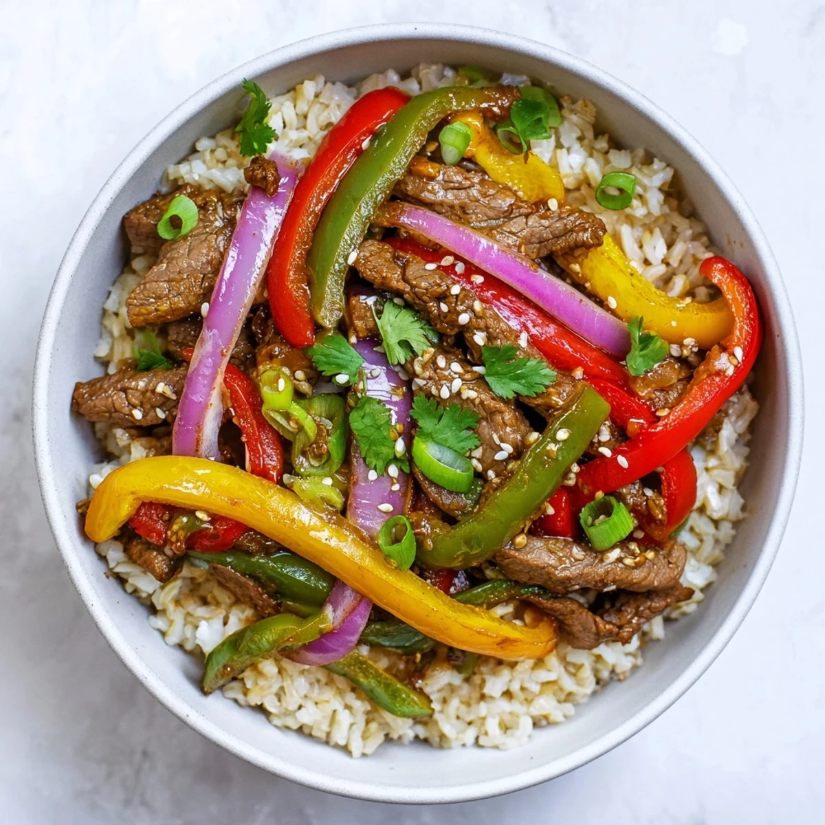 Freshly stir-fried Healthy Beef and Pepper Rice Bowl with tender beef, crisp bell peppers, and steaming brown rice.
