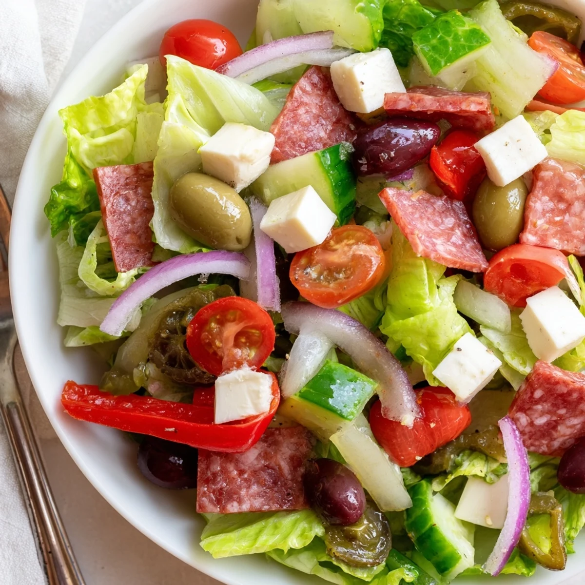 Fresh Italian chopped salad featuring crisp vegetables, cured meats, cheese and zesty homemade Italian dressing