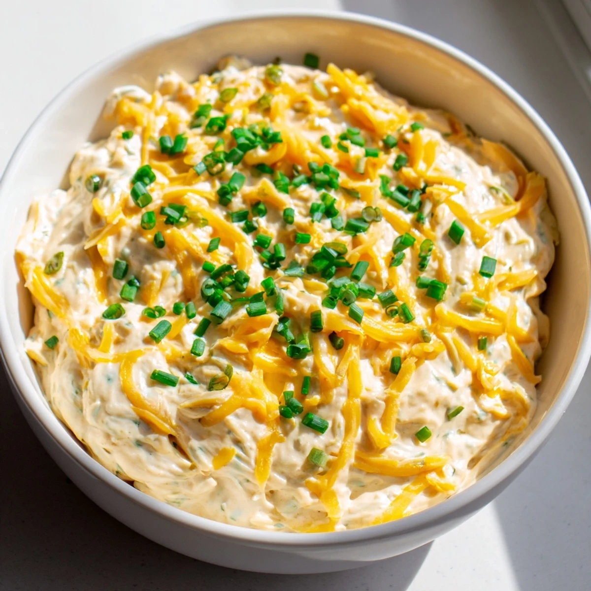 Rich savory pretzel dip featuring Dijon mustard and garlic alongside warm soft pretzels