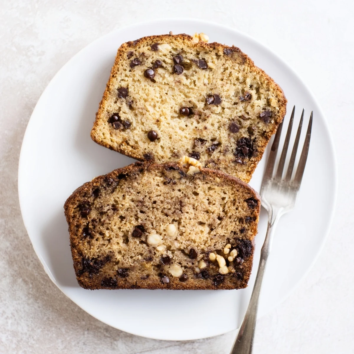 Golden brown super moist chocolate chip banana bread loaf studded with melted chocolate chunks