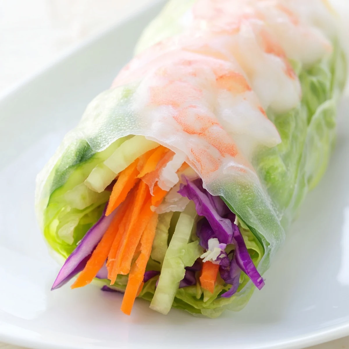 Golden shrimp and colorful vegetables wrapped in delicate rice paper with creamy peanut dipping sauce