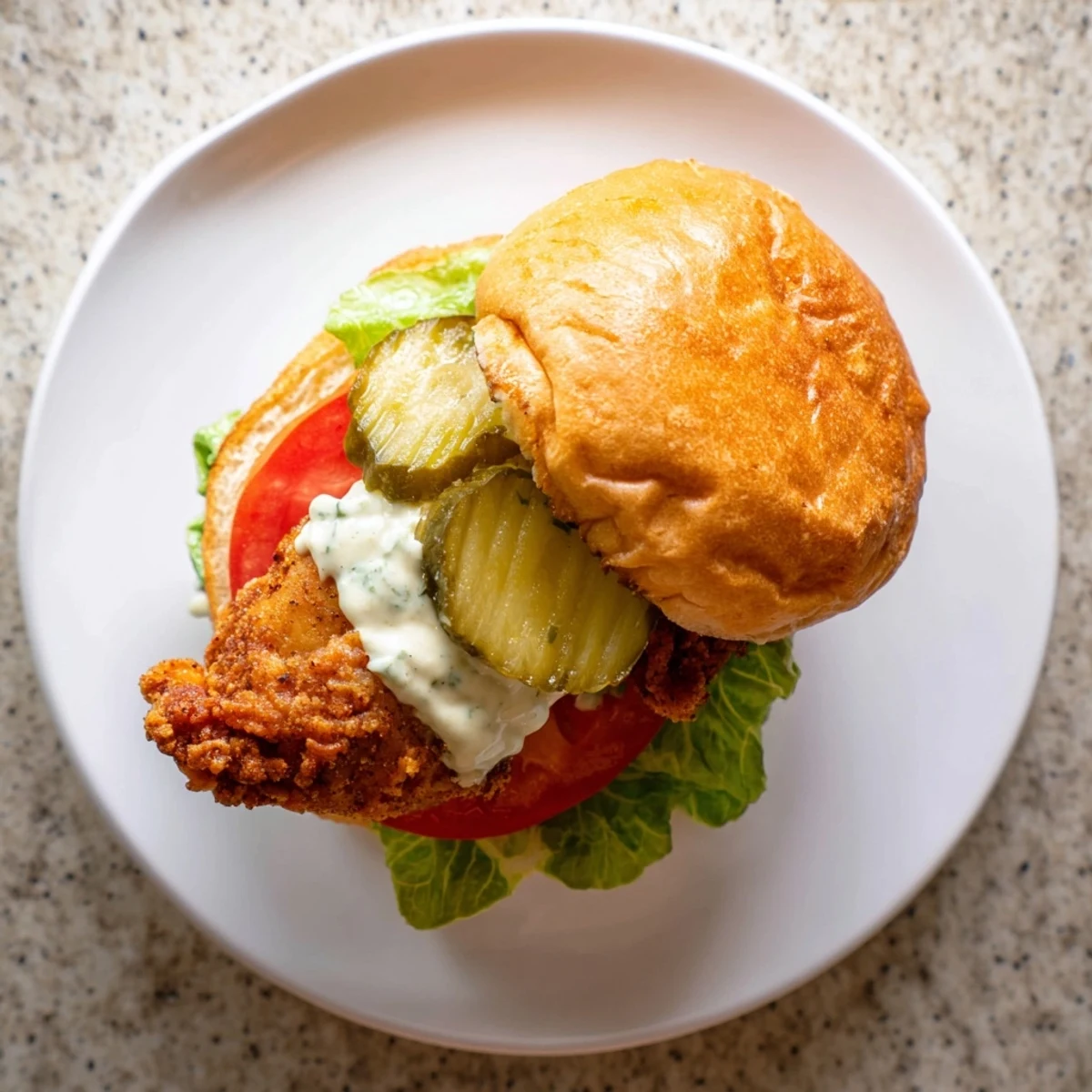 Crispy Cajun seasoned chicken stacked high on toasted bun with tangy garlic mayo and crisp romaine