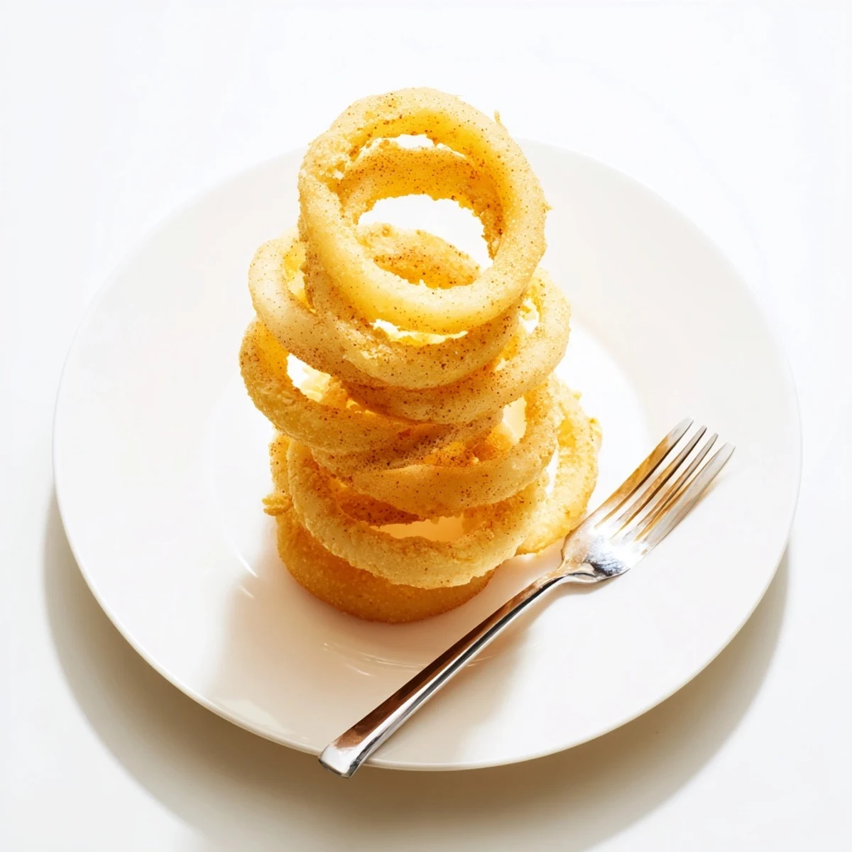 Basket of crunchy chip-style onion rings perfect for snacking and dipping