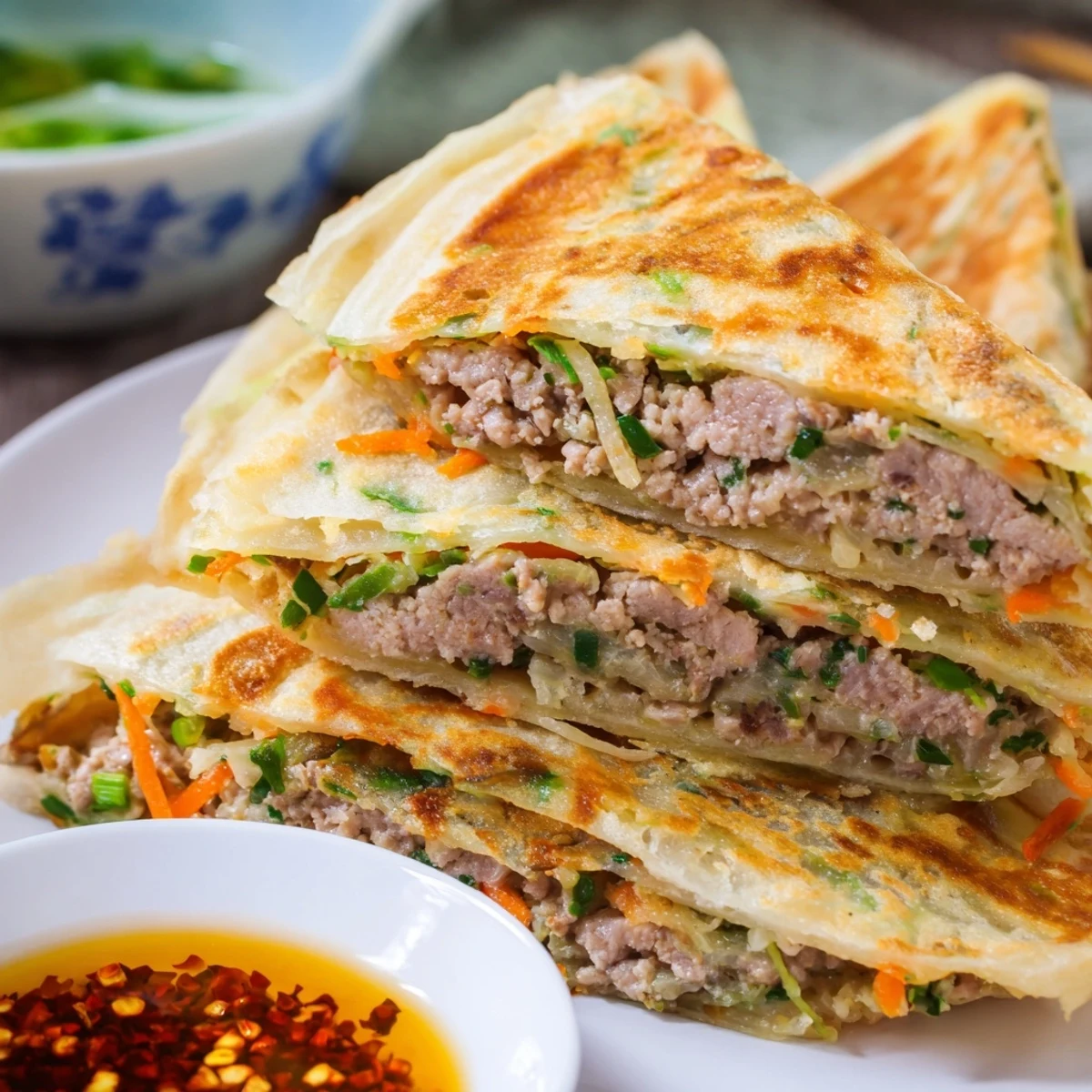 Golden Chinese style savoury stuffed breakfast pancakes with fluffy egg and meat filling folded inside