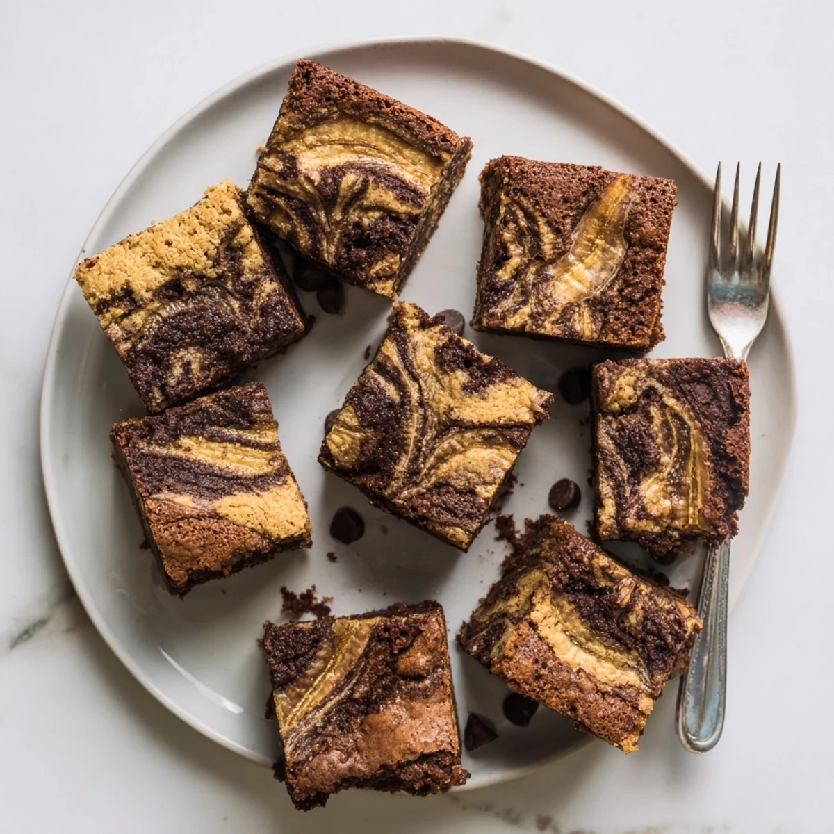 Sliced banana bread brownie bars showing the marbled chocolate and banana interior on a serving platter