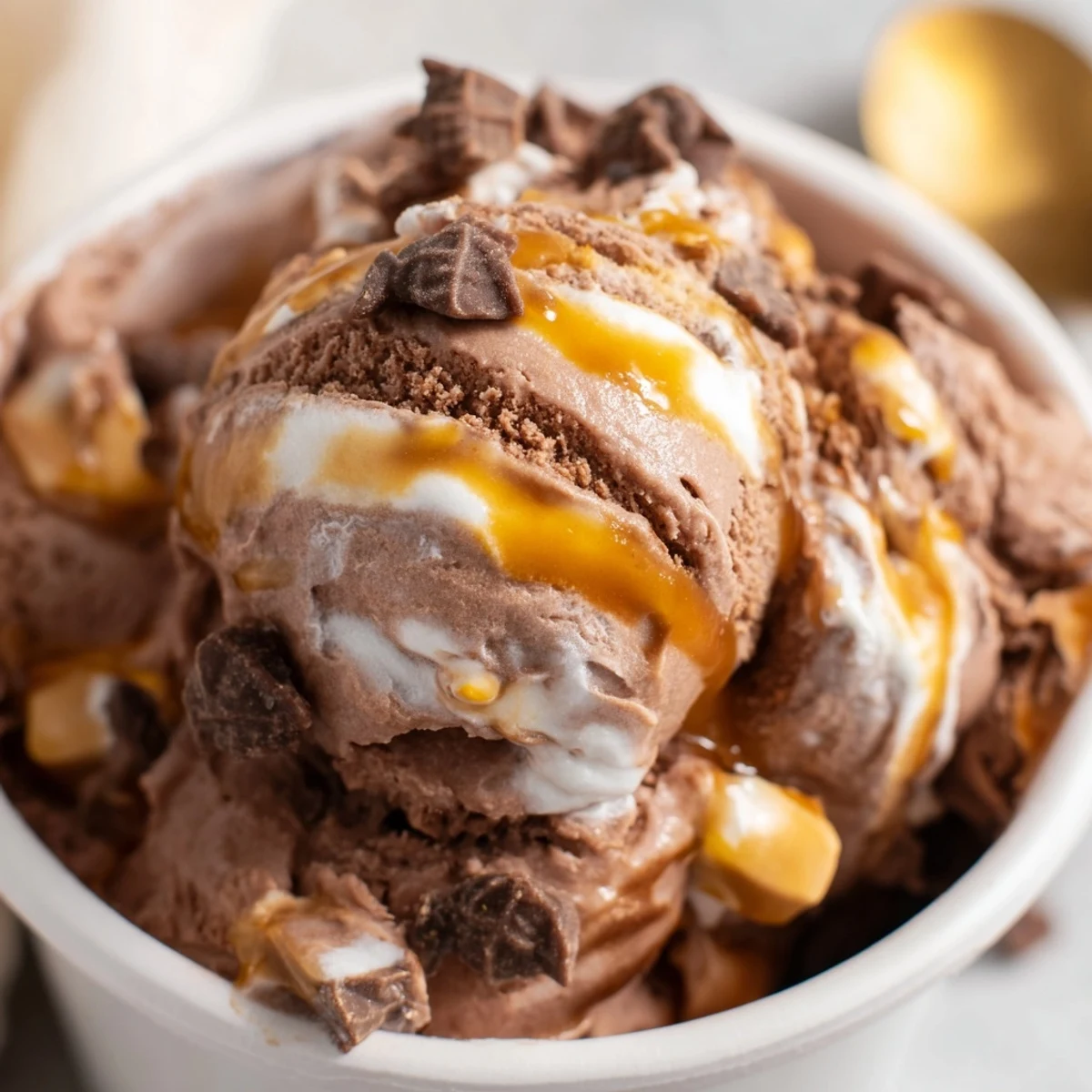 Rich homemade Ninja Creami Phish Food ice cream featuring marshmallow swirls in a chilled glass bowl