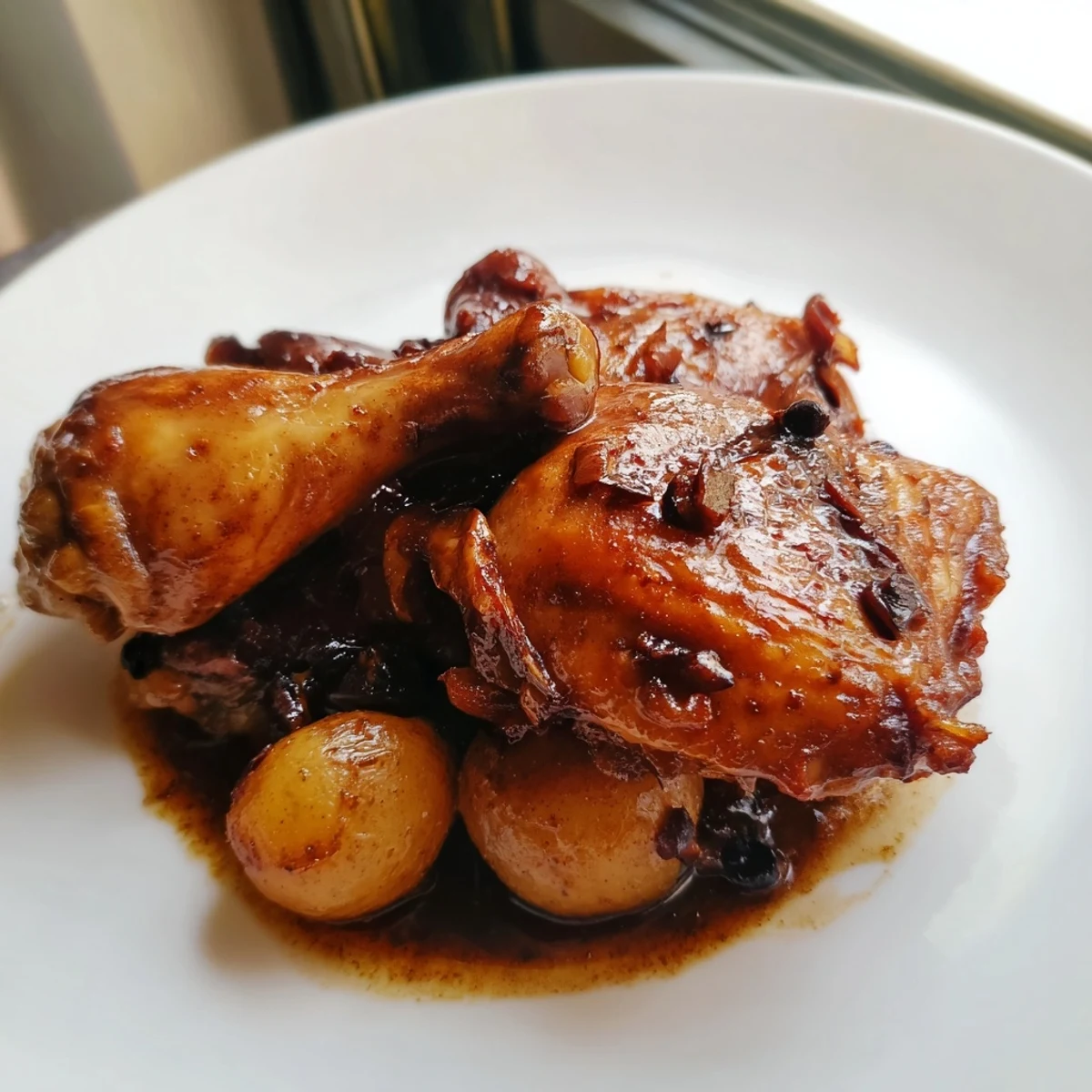 Savory Filipino Chicken Adobo with reduced sticky glaze served alongside fluffy jasmine rice and crispy fried garlic
