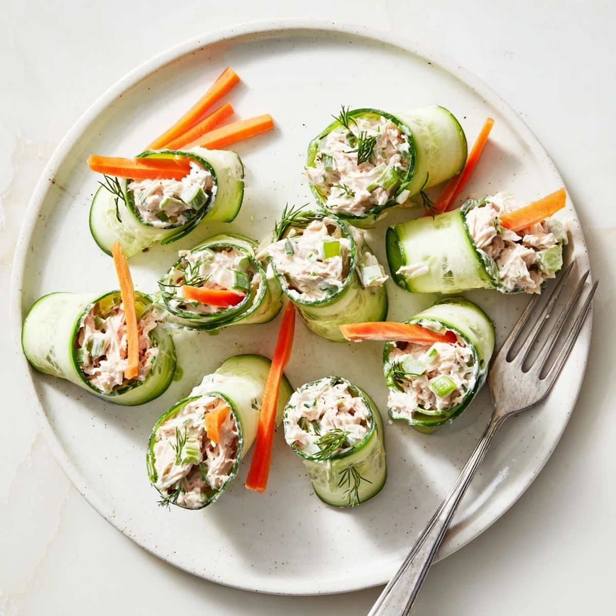 Crisp cucumber slices rolled with savory chicken salad filling create easy low-carb bite-sized snacks
