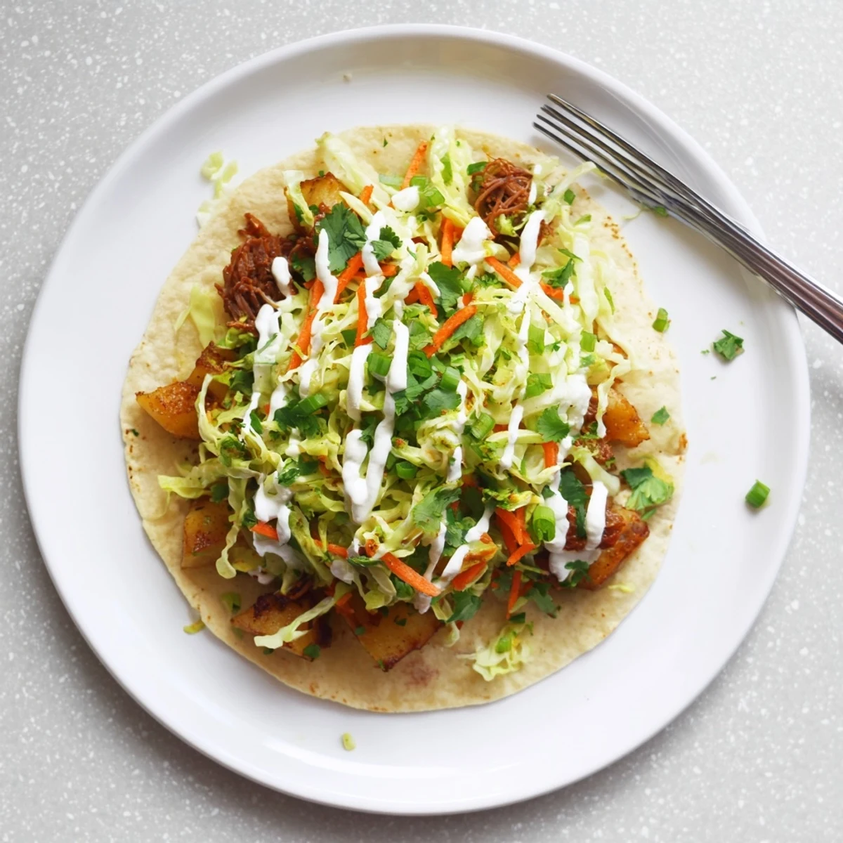 Warm flour tortillas filled with tender corned beef, crispy potatoes, and crunchy cabbage slaw