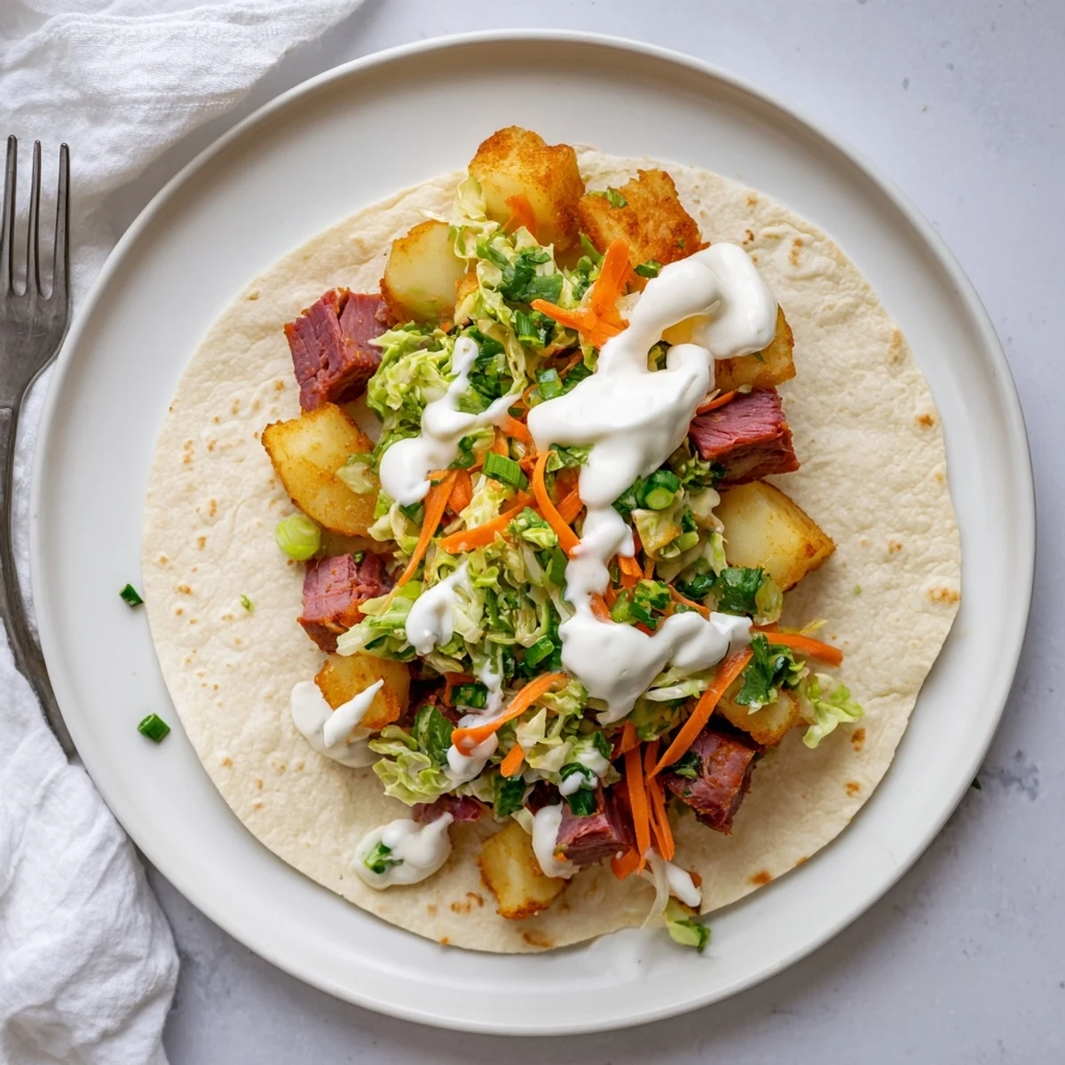 Irish tacos stacked high with shredded beef, golden potatoes, and fresh zesty cabbage topping