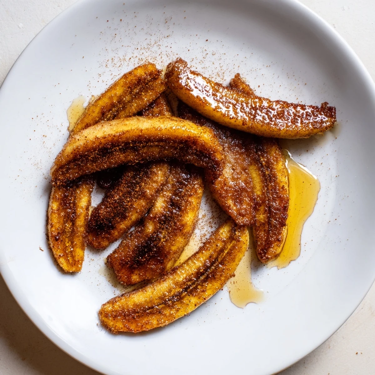 Golden pan fried cinnamon bananas sizzling in butter with caramelized edges