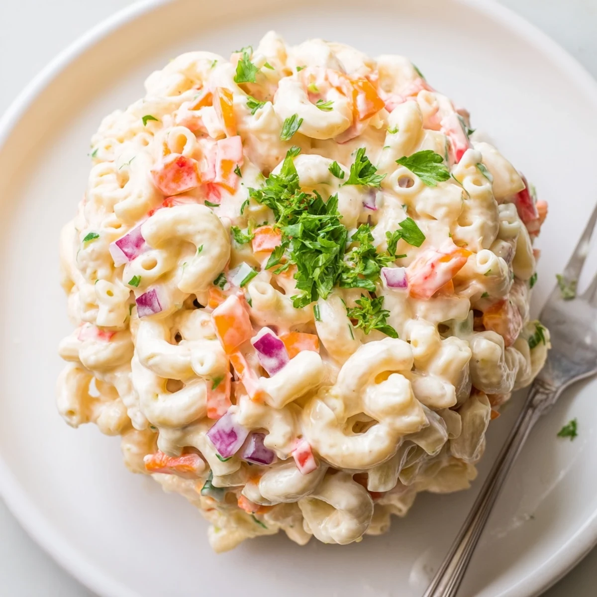 Classic American macaroni salad featuring tender pasta in rich dressing with crunchy red peppers