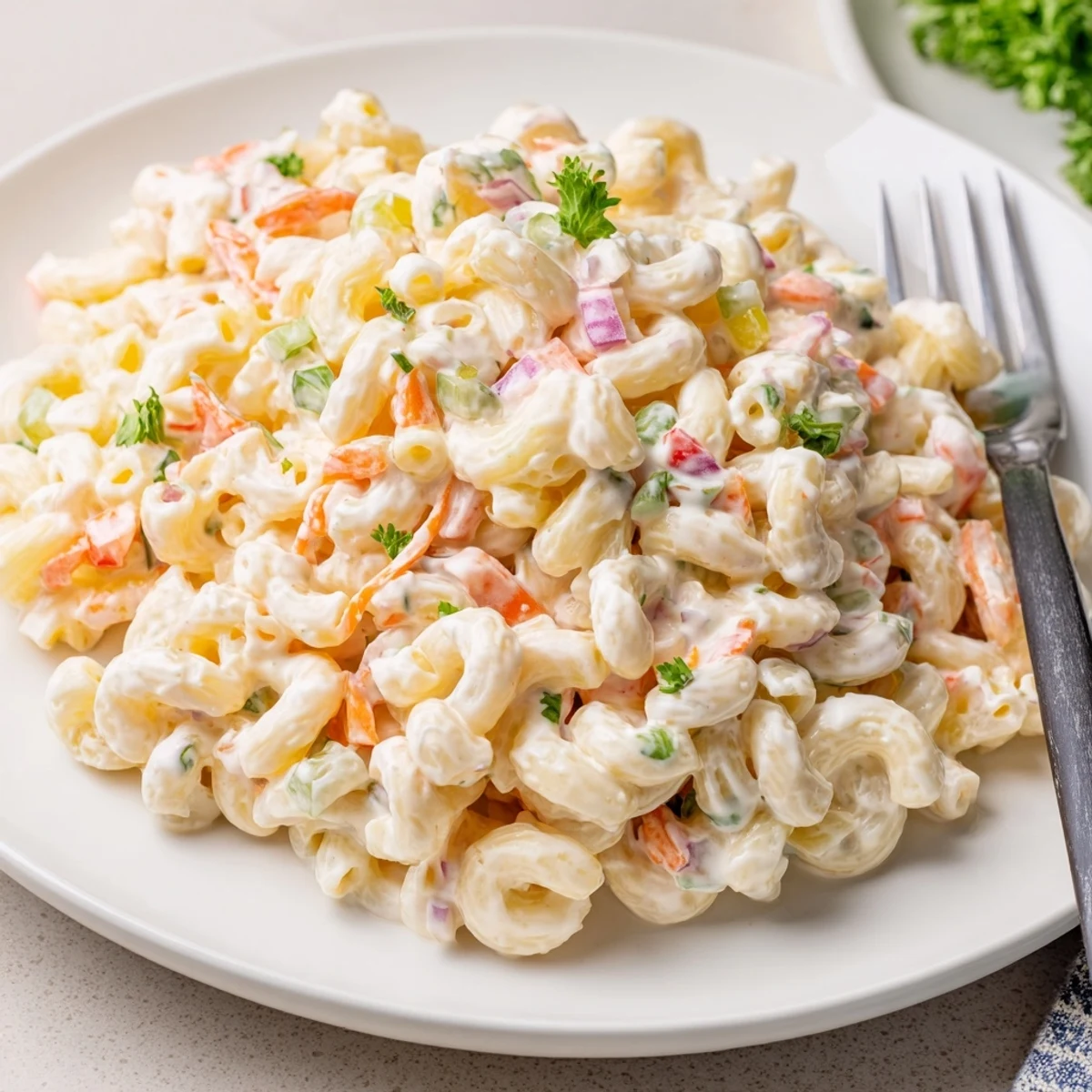 Crowd-pleasing tangy and creamy macaroni salad served chilled for summer picnics and barbecues