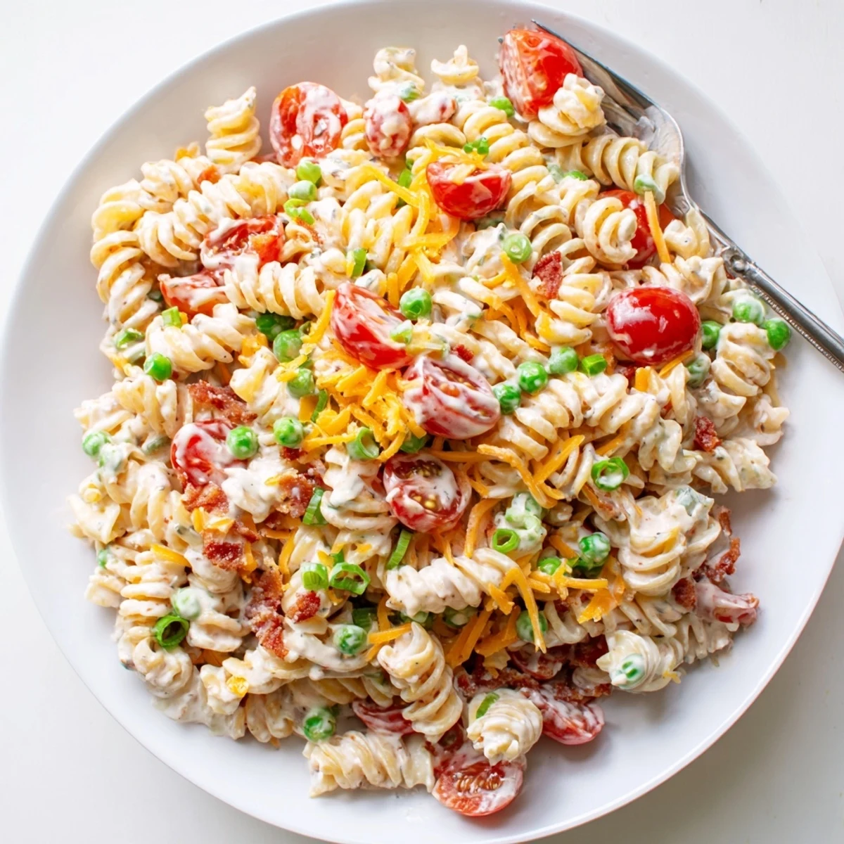 Colorful addictive crack pasta salad mounded in a bowl with crunchy veggies and creamy ranch dressing