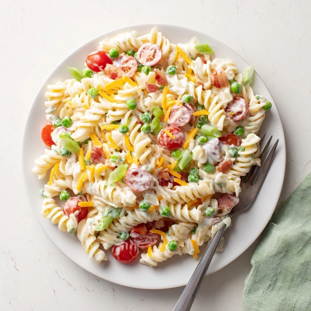 A close-up of addictive crack pasta salad showing rotini coated in rich cheddar-bacon ranch sauce