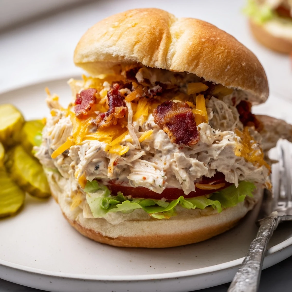 Bubbly baked Crack Chicken Sandwiches spooned warm onto buns, perfect for gatherings