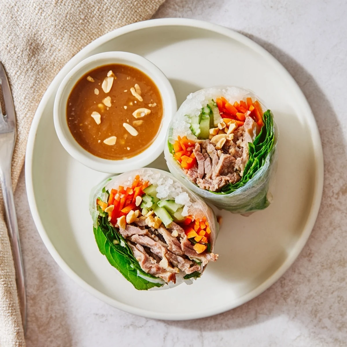 Thai Basil Beef Rolls arranged on a plate with dipping sauce, glossy.