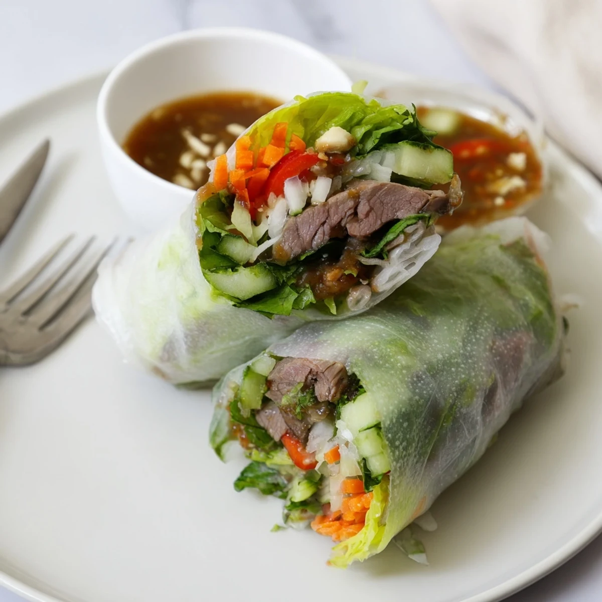 Sliced Thai Basil Beef Rolls showing tender slices, crisp vegetables, fragrant basil.