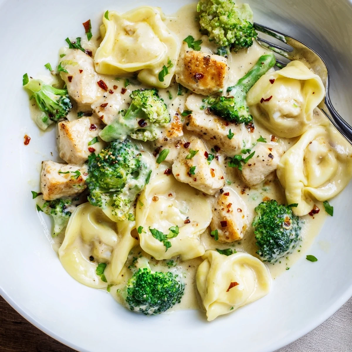 A hearty bowl of Creamy Garlic Parmesan Tortellini Chicken Broccoli Recipe, garnished with Parmesan