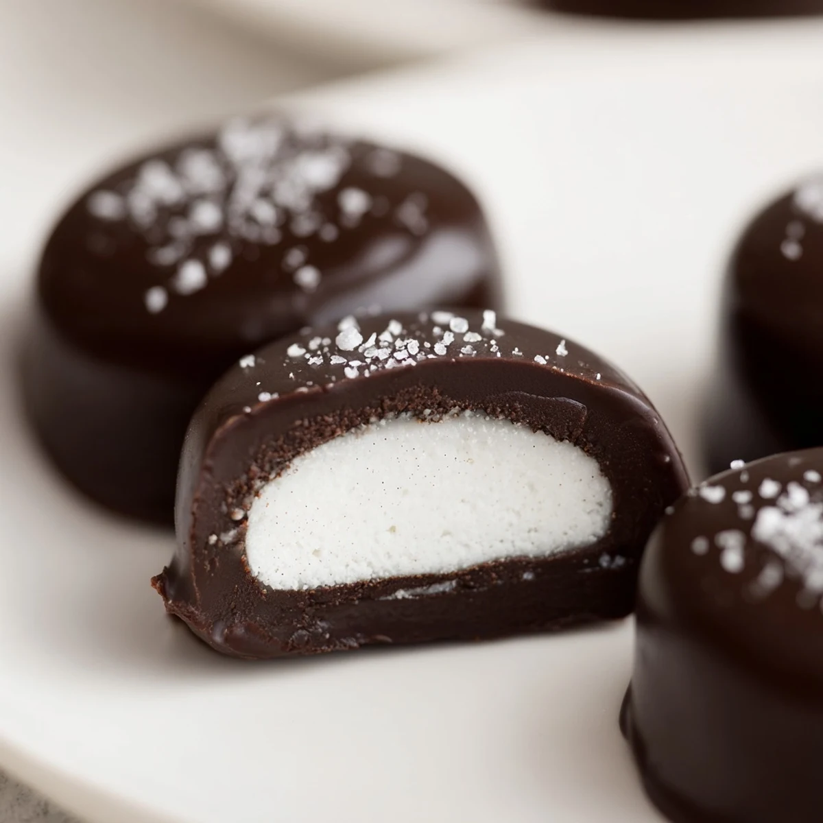 Peppermint Patties with glossy dark chocolate, cool mint center on parchment