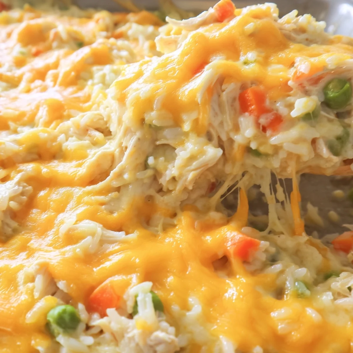 Comforting chicken and rice bake featuring bubbly cheese sauce and golden brown crust
