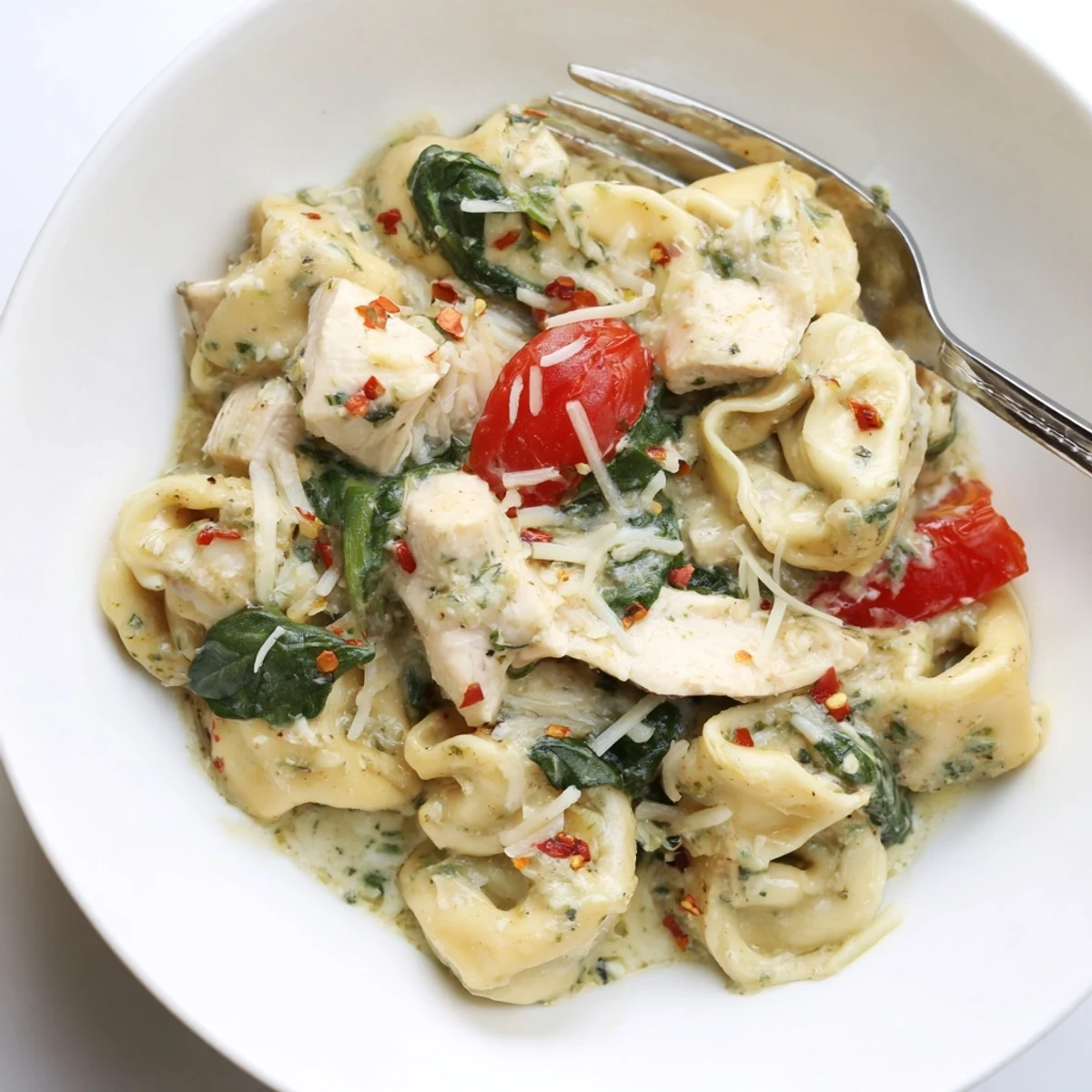 Melty cheese and basil aroma in Slow Cooker Tortellini Casserole With Cheesy Chicken Pesto