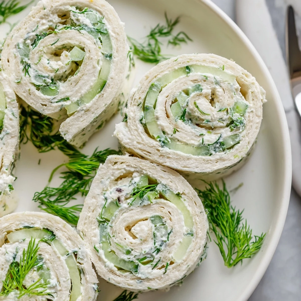 Bright Cucumber And Dill Pinwheels sliced into spirals, herb-scented party appetizer  