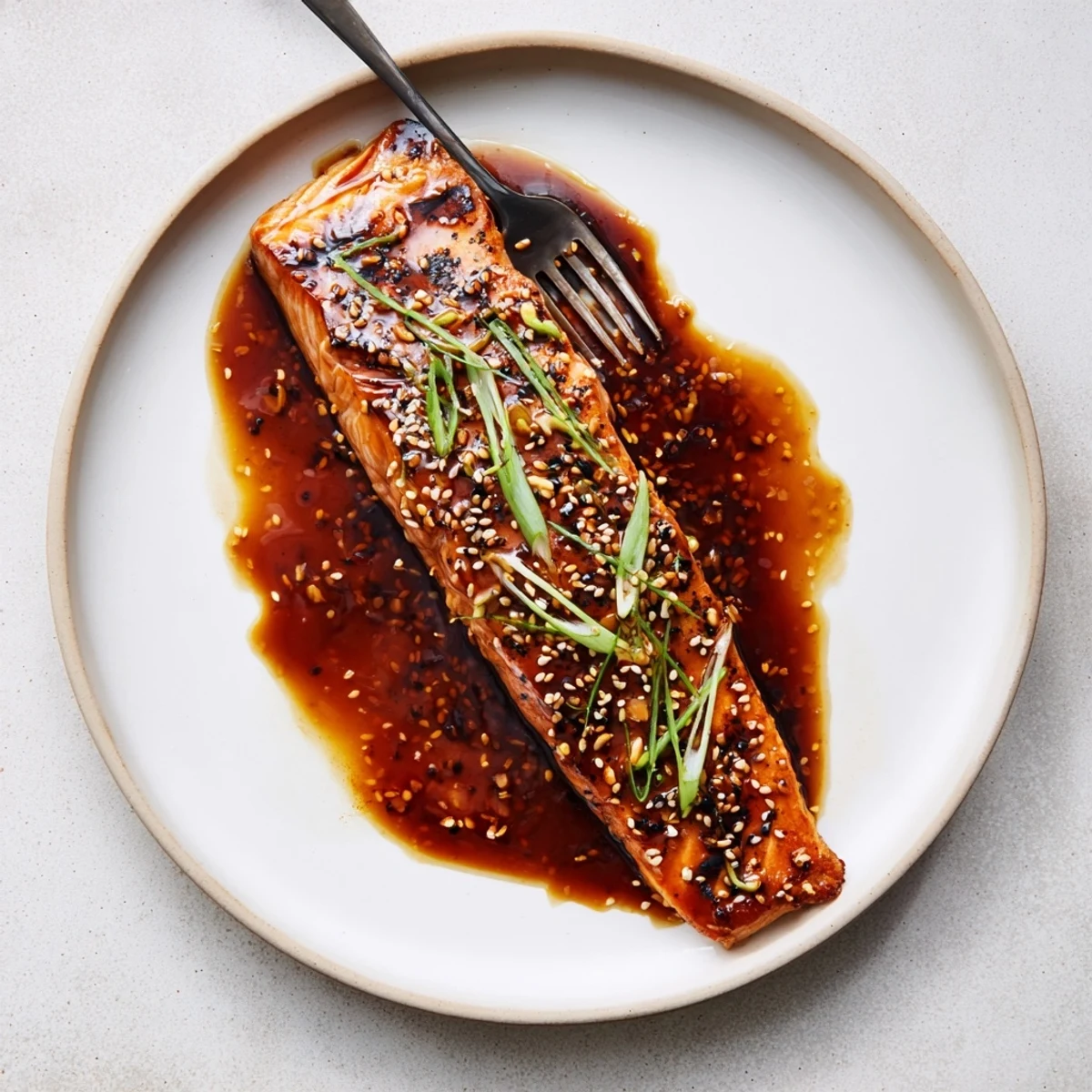 Caramelized gluten free teriyaki salmon fillet drizzled with thick, sticky, homemade sauce