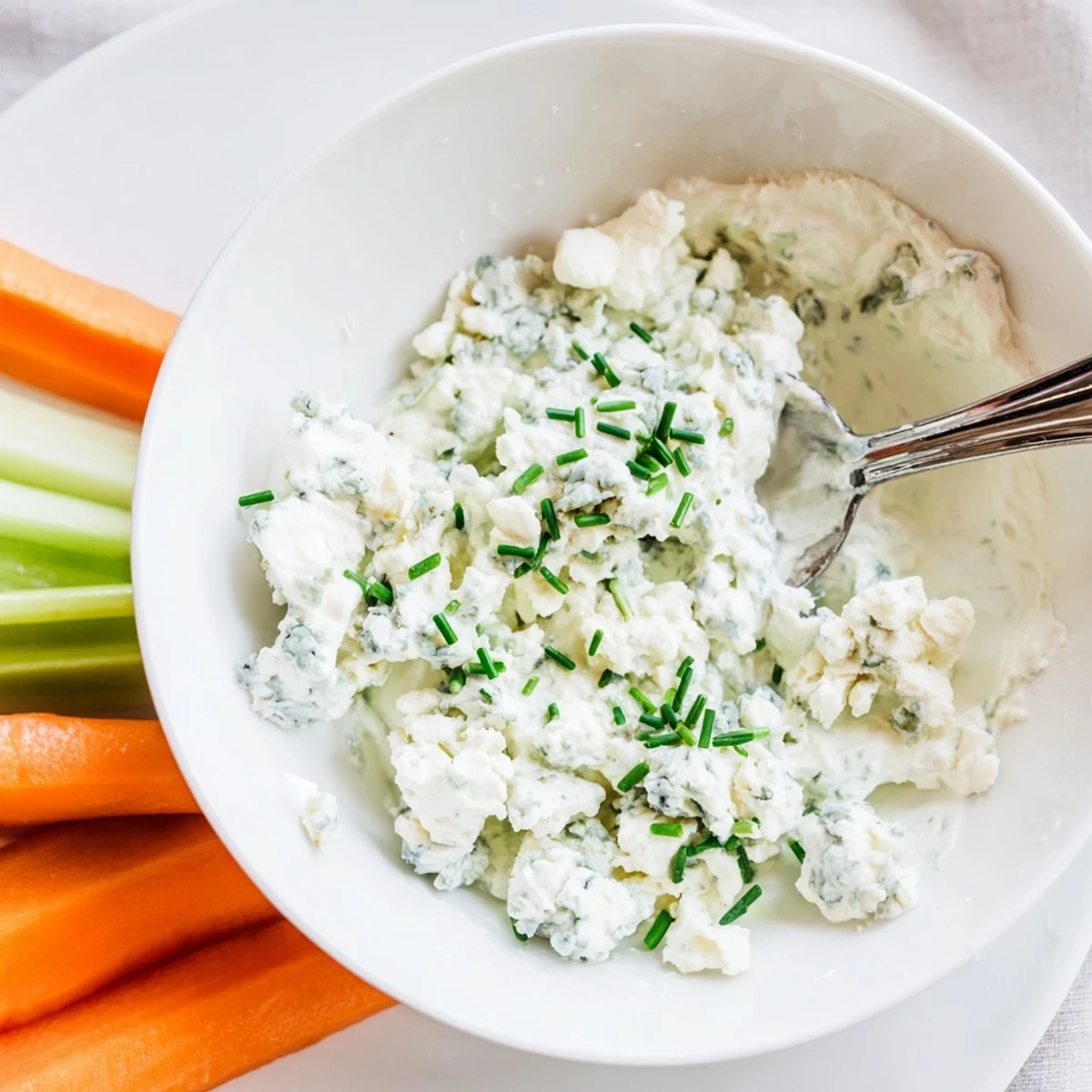 Thick blue cheese dip topped with crumbled cheese and fresh snipped chives