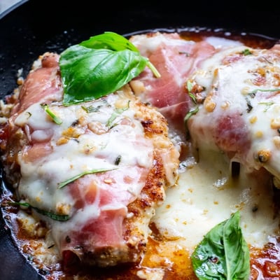 Crispy chicken Valdostana layered with savory prosciutto and bubbling cheese fresh from the oven